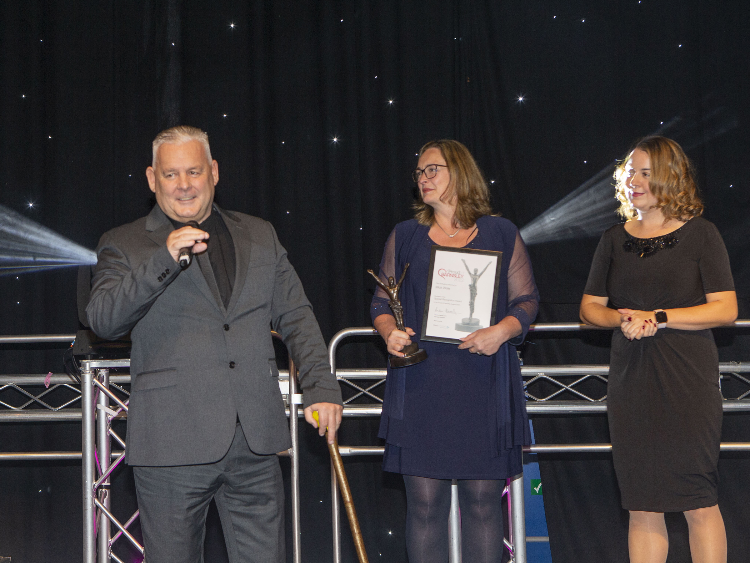 three people award microphone